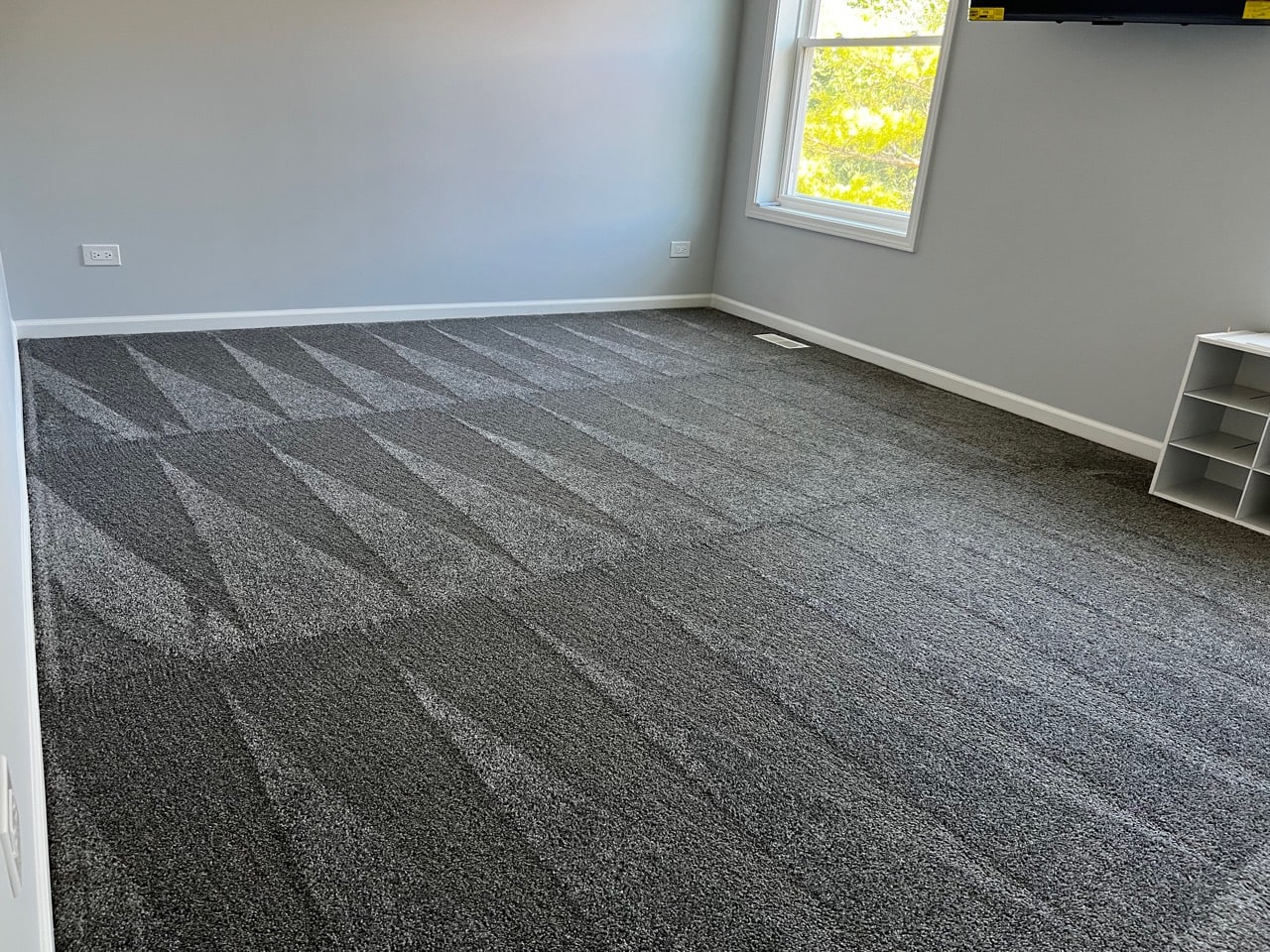 Crisp vacuum lines across gray bedroom carpet